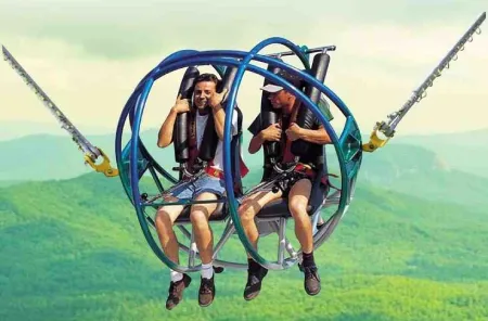 Two people enjoying reverse bungee in Rishikesh with a safety harness