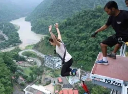 A girl jumping from 117 meter bungee platform during bungee jumping in Rishikesh