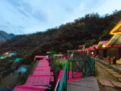 Luxury camping in Rishikesh with swimming pool, cottages and evening lights