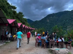 People relaxing and enjoying the evening at the campsite in Rishikesh