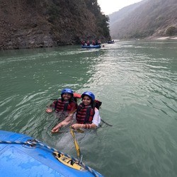 A beautiful couple enjoying body surfing in Rishikesh in the Ganga River
