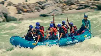 Rafting group with a guide enjoying river rafting in Rishikesh