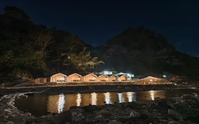 Riverside camping in Rishikesh with beautiful river and mountain views